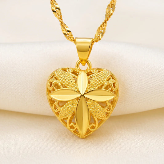 Sterling silver heart shaped pendant necklace lying flat on a white marble background.